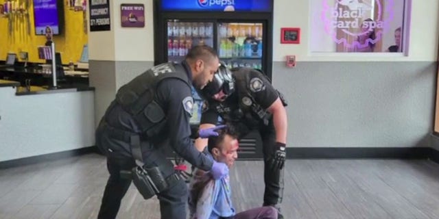 Police arrive and subdue an armed attacker at a Planet Fitness gym in California.