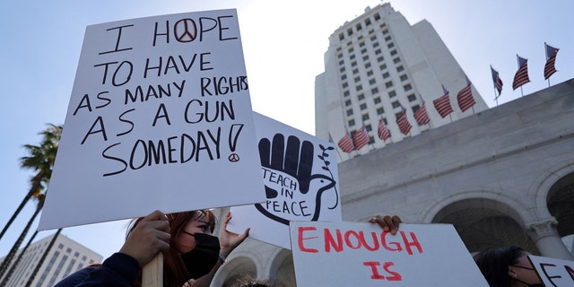 Activists hold sign during a demonstration in front of Los Angeles City Hall to protest U.S. gun violence on May 31, 2022.