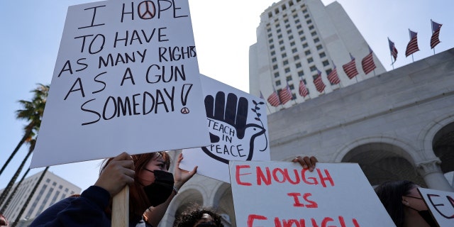 Activists hold sign during a demonstration in front of Los Angeles City Hall to protest U.S. gun violence on May 31, 2022.