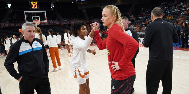 Texas Longhorns' Rory Harmon, center left, and Louisville Cardinals' Hailey Van Lith, center right, bump fists during the second round of the 2023 NCAA Women's Tournament at the Moody Center on March 20, 2023 in Austin, Texas.