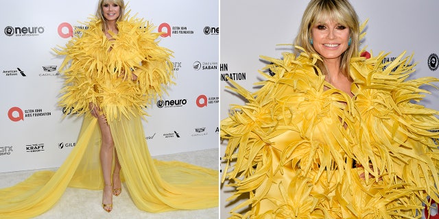 Heidi Klum wore an over the top yellow feathery gown at the Elton John Aids Foundation Oscars watch party.