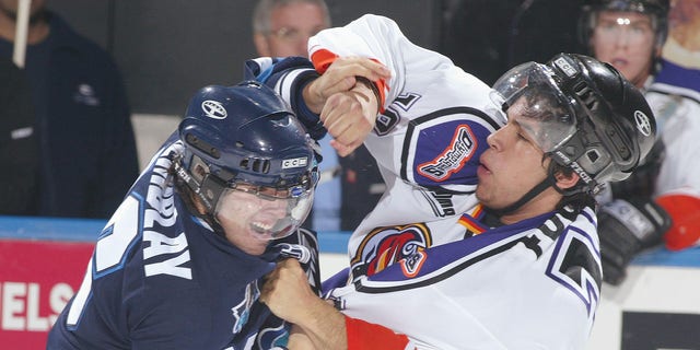 Rimouski Oceanique's Erick Tremblay, left, fights against Gatineau Olympiques' Nick Fugere during a Quebec Major Junior Hockey League game at the Robert Guertin Arena in Gatineau, Quebec, Canada, on November 13, 2004.