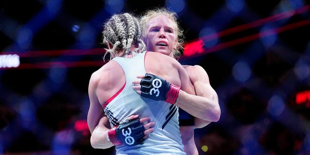 Holly Holm hugs Yana Santos during their bantamweight fight at the AT&T Center on March 25, 2023 in San Antonio, Texas.