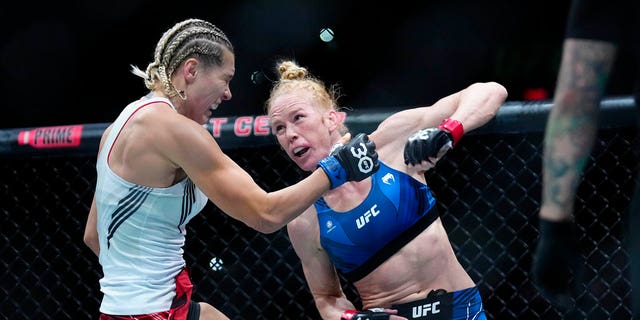 Holly Holm punches Yana Santos during the UFC on ESPN 43 event at AT&amp;T Center on March 25, 2023, in San Antonio. 