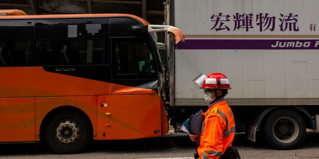 An ambulance worker inspects after an accident on a highway in Hong Kong, on March 24, 2023.