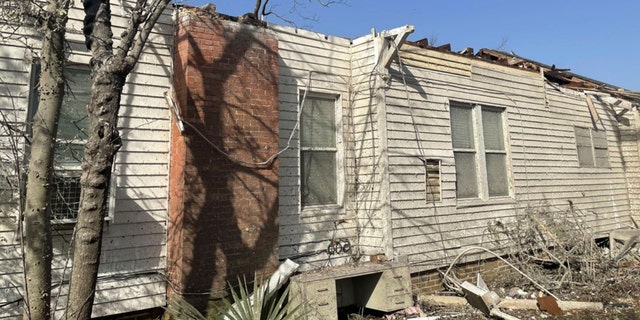 The roof of a home is damaged with debris covering the ground on Saturday, March 25, 2023 in Silver City, Miss.