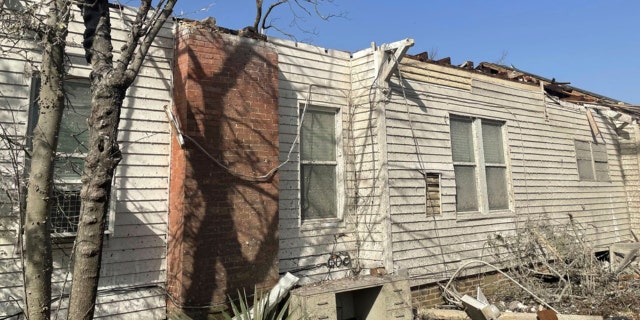 The roof of a home is damaged with debris covering the ground on Saturday, March 25, 2023 in Silver City, Miss.