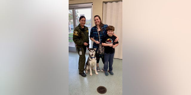 Lieutenant Ollinger (far left) was present to pass Harvey along to his new family, Lankston (middle) and her son Harrison (far right).