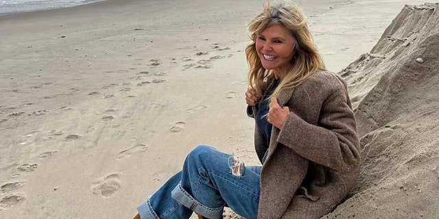 Christie Brinkley debuted her new gray hair while happily posing on the beach.