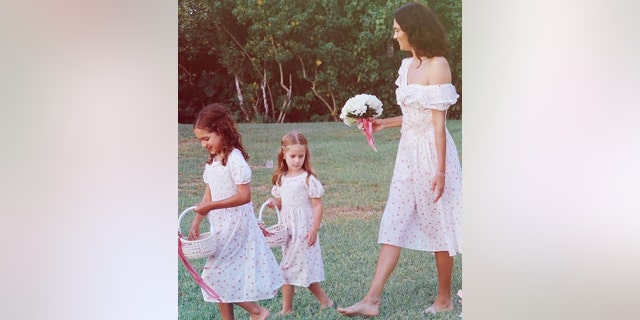 Emma Heming Willis walks alongside her daughters and flower girls Mabel Ray and Evelyn Penn at her vow renewal to their father Bruce Willis.