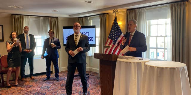 House Speaker Kevin McCarthy gives Rep. Derrick Van Orden one of the 32 checks for incumbent House Republicans.