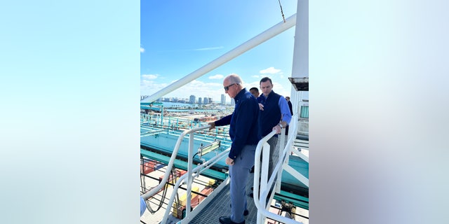 Rep. Gimenez, front, and Rep. Gallagher, back, astatine the Port of Miami.