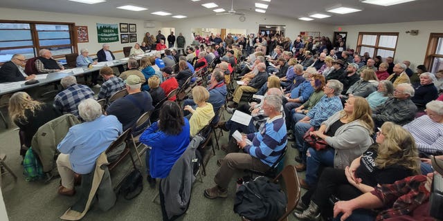 Local community members gather at a Green Charter Township board meeting on March 14, 2023 to express their anger over plans for a Chinese-owned company to construct a battery plant in the area.