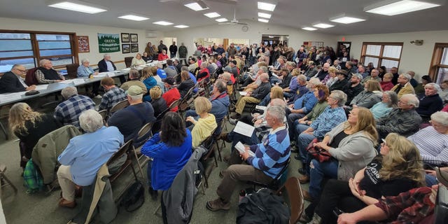 Community members gather at a Green Charter Township board meeting March 14, 2023, to express anger over plans a Chinese-owned company has to construct a battery plant.