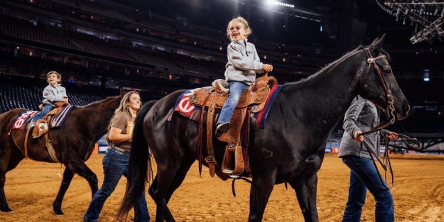 Casey DeSantis and her two children, Madison and Mason at the Houston Livestock Show and Rodeo on Friday, March 3, 2023.