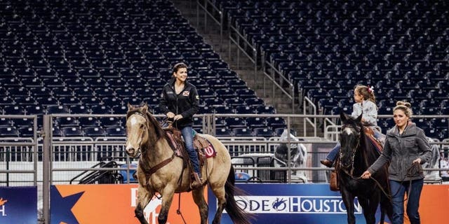 Casey DeSantis (center) and her two children, Madison and Mason, at the Houston Livestock Show and Rodeo on Friday, March 3, 2023.