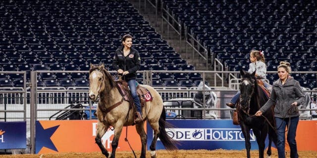 Casey DeSantis (C) and her two children, Madison and Mason at the Houston Livestock Show and Rodeo on Friday, March 3, 2023.