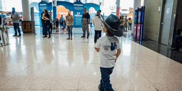 Casey DeSantis and her two children, Madison and Mason attend the Houston Livestock Show and Rodeo on Friday, March 3, 2023.