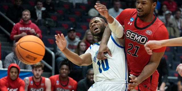 Texas A&M Corpus Christi's Isaac Mushila (10) and Southeast Missouri State's Josh Earley (21) vies for a rebound during the first half of a First Four college basketball game in the NCAA men's basketball tournament, Tuesday, March 14, 2023, in Dayton, Ohio.