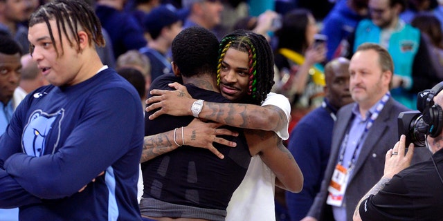 Memphis Grizzlies guard Ja Morant, center right, hugs Dallas Mavericks guard Kyrie Irving after a game Monday, March 20, 2023, in Memphis. 