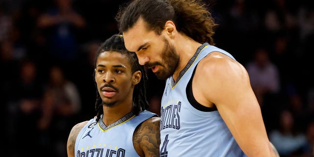 Ja Morant, #12, and Steven Adams, #4 of the Memphis Grizzlies, interact in the second quarter of a game against the Minnesota Timberwolves at the Target Center on November 30, 2022 in Minneapolis.