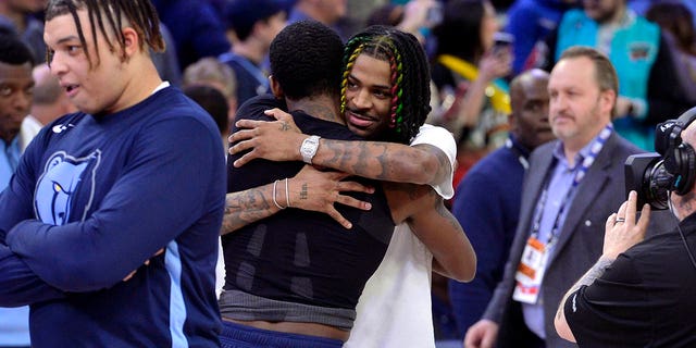 Grizzlies guard Ja Morant hugs Dallas Mavericks guard Kyrie Irving after their game on Monday, March 20, 2023, in Memphis.