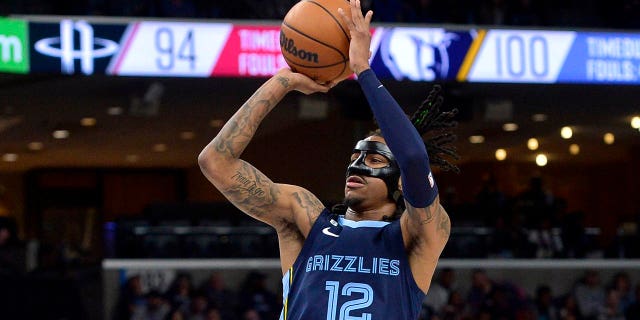 Memphis Grizzlies guard Ja Morant, #12, shoots the ball in the second half of an NBA basketball game against the Houston Rockets Wednesday, March 22, 2023, in Memphis, Tennessee.