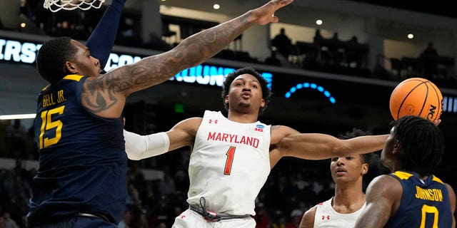 Maryland guard Jahmir Young (1) attempts a layup past West Virginia forward Jimmy Bell Jr. (15) in the first half of a first-round college basketball game in the NCAA Tournament in Birmingham, Ala., Thursday, March 16, 2023.