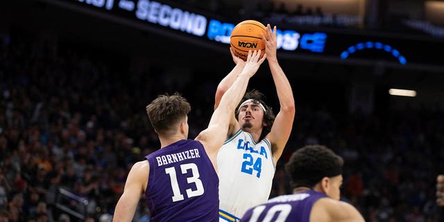 UCLA quarterback Jaime Jaques Jr.  (24) shoots Northwest defenseman Brooks Barnheiser (13) during the first half of the second round of the men's basketball game at the NCAA Men's Tournament, Saturday, March 18, 2023, in Sacramento, California.
