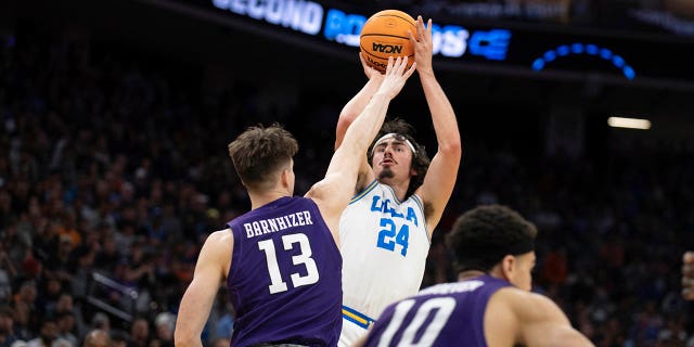 UCLA guard Jaime Jaquez Jr. (24) shoots over Northwestern guard Brooks Barnhizer (13) during the first half of a second-round college basketball game in the men's NCAA Tournament, Saturday, March 18, 2023, in Sacramento, Calif.