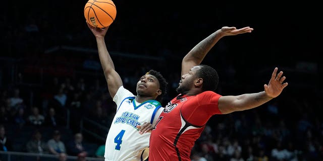 Texas A&M Corpus Christi's Jalen Jackson (4) shoots against Southeast Missouri State's Phillip Russell (1) during the first half of a First Four college basketball game in the NCAA men's basketball tournament, Tuesday, March 14, 2023, in Dayton, Ohio.