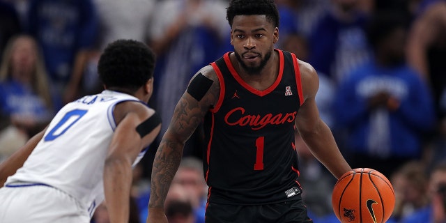 Jamal Shead of the Houston Cougars handles the ball during the second half against Elijah McCadden of the Tigers at FedExForum on March 5, 2023, in Memphis, Tennessee.