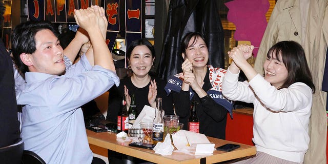 Team supporters gesture as Team Japan scored against Italy at the World Baseball Classic, at a sports bar in Tokyo, Thursday, March 16, 2023.