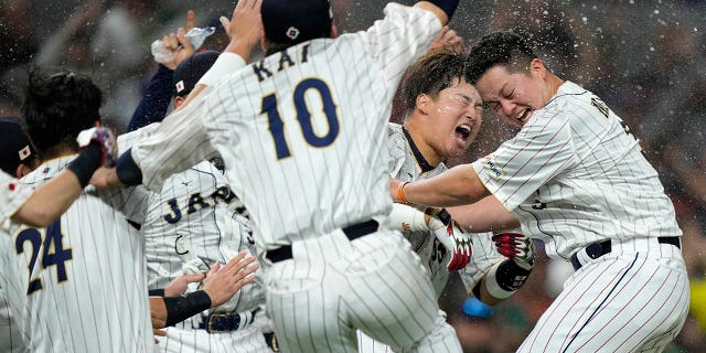 Japan players celebrate after defeating Mexico in a World Baseball Classic game, Monday, March 20, 2023, in Miami.