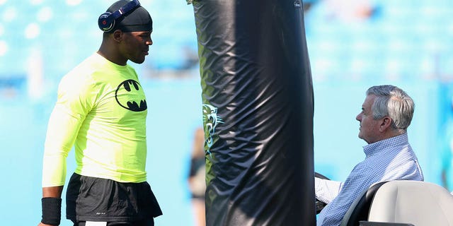 Cam Newton #1 of the Carolina Panthers talks with team owner Jerry Richardson during warmups before their game against the Miami Dolphins at Bank of America Stadium on August 22, 2015 in Charlotte, North Carolina. 