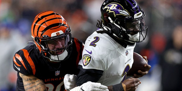 Jessie Bates III #30 of the Cincinnati Bengals tackles Tyler Huntley #2 of the Baltimore Ravens during the fourth quarter in the AFC Wild Card playoff game at Paycor Stadium on January 15, 2023 in Cincinnati, Ohio.