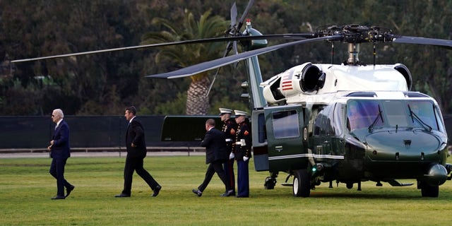 President Biden, left, arrives on Marine One Monday, March 13, 2023, in Del Mar, California, as he heads to a fundraiser.