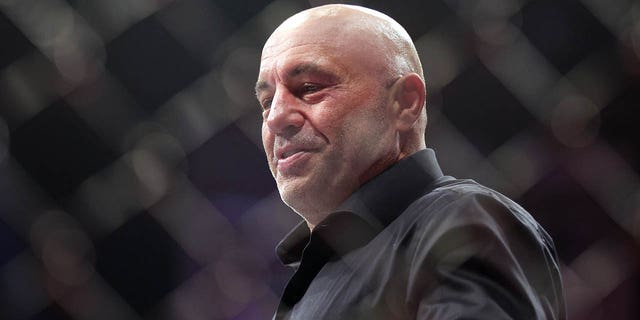 Joe Rogan walks inside the Octagon during the UFC 282 event at T-Mobile Arena in Las Vegas on Dec. 10, 2022.
