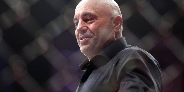 Joe Rogan walks inside the Octagon during the UFC 282 event at T-Mobile Arena in Las Vegas on Dec. 10, 2022.