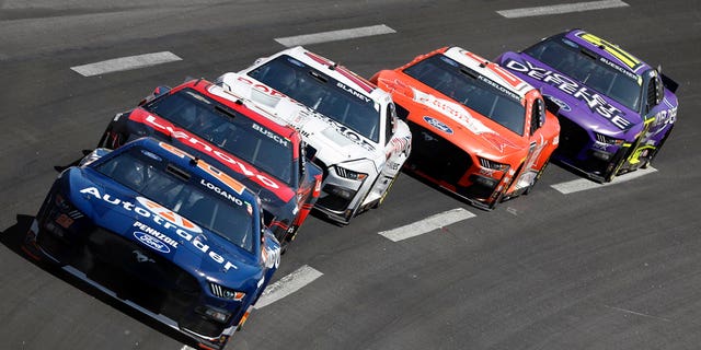 Joey Logano leads a pack of cars through Turn 4 during the NASCAR Cup Series auto race at Atlanta Motor Speedway, Sunday, March 19, 2023, in Hampton, Ga. 