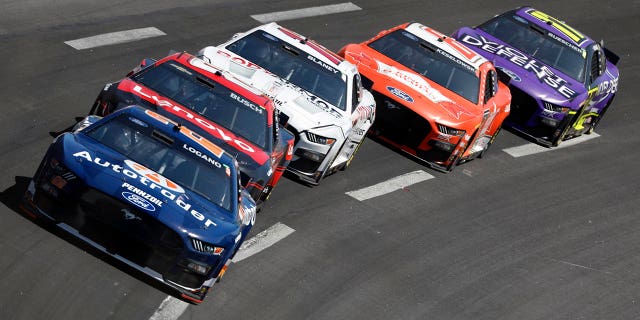 Joey Logano leads a pack of cars through Turn 4 during the NASCAR Cup Series auto race at Atlanta Motor Speedway, Sunday, March 19, 2023, in Hampton, Ga.