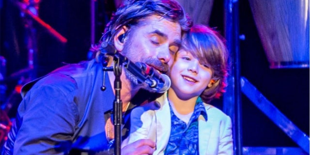 John Stamos brought his son, Billy, onstage to help him during his performance with The Beach Boys.