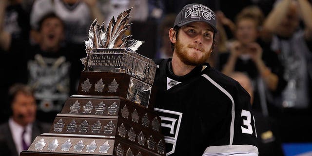 Goalie Jonathan Quick, #32 of the Los Angeles Kings, holds the Conne Smythe Trophy for Most Valuable Player in the NHL Playoffs after the Los Angeles Kings defeated the New Jersey Devils 6-1 in Game Six to win the series 4-2 of the 2012 Stanley Cup Final at Staples Center on June 11, 2012 in Los Angeles.