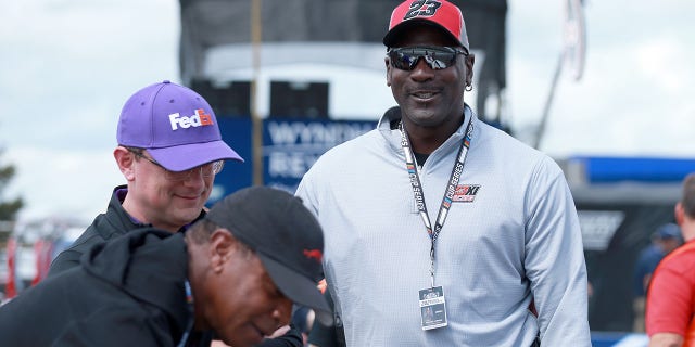 NBA Hall of Famer Michael Jordan meets with co-owner of 23XI Racing Denny Hamlin, driver of the #11 FedEx Ground Toyota, , prior to the NASCAR Cup Series Pocono Organics CBD 325 at Pocono Raceway on June 26, 2021 in Long Pond, Pennsylvania.