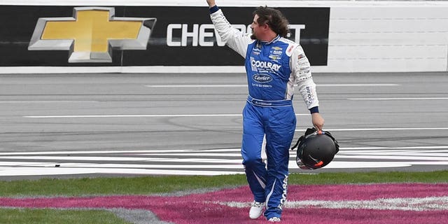 Josh Williams waves to the crowd after leaving his car during the NASCAR Xfinity Series Raptor King of Tough 250 on March 18, 2023, at Atlanta Motor Speedway.