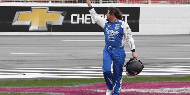 Josh Williams waves to the crowd after leaving his car during the NASCAR Xfinity Series Raptor King of Tough 250 on March 18, 2023, at Atlanta Motor Speedway.