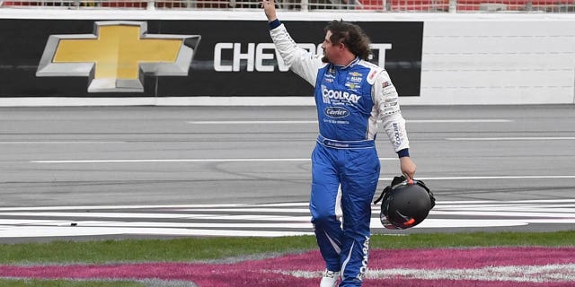 Josh Williams waves to the crowd after leaving his car during the NASCAR Xfinity Series Raptor King of Tough 250 on March 18, 2023 at Atlanta Motor Speedway.