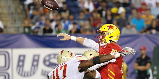 KJ Costello, number 19 of the Philadelphia Stars, throws a touchdown pass during the fourth quarter when he is hit by DeMarquis Gates, number 47 of the Birmingham Stallions, in the USFL championship game at Tom Benson Hall Of Fame Stadium on July 3, 2022 in Canton, Ohio.