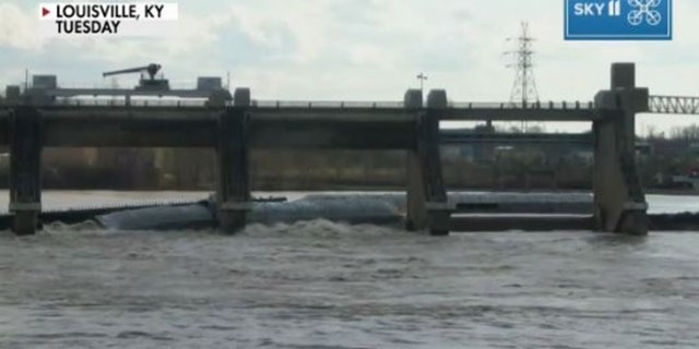 One barge is carrying 1,400 tons of methanol and is partially submerged at the McAlpine Dam.