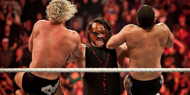 Kane taking down two top stars during WWE "Raw" event at the Rose Garden Arena in Portland, Oregon on February 27, 2012.